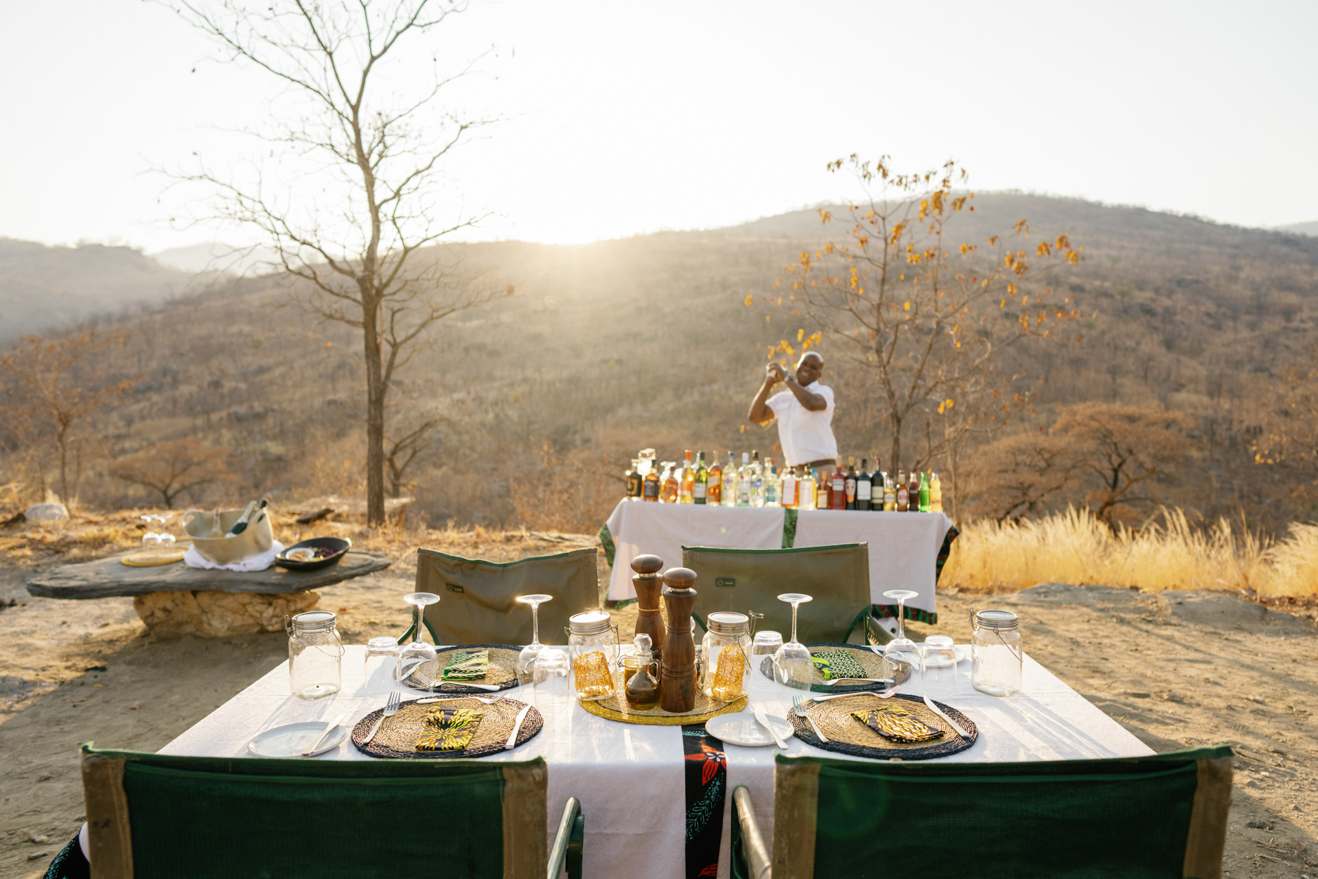 Evening sunset bar and dinner setup at the sleepout under the stars in the Lower Zambezi with Time + Tide Safaris in Zambia